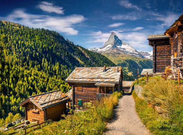 Sunny summer morning in Zermatt village Sunny summer morning in Zermatt village with Matterhorn (Monte Cervino, Mont Cervin) peak on backgroud. Beautiful outdoor scene in  Swiss Alps, Valais canton, Switzerland, Europe. valais canton stock pictures, royalty-free photos & images