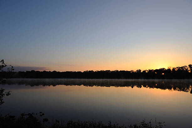 Sunrise cross the lake stock photo