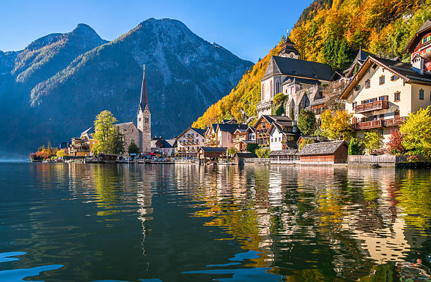 Sunrise in Hallstatt mountain village with Hallstatter See in fall Scenic panoramic picture-postcard view of famous Hallstatt mountain village with Hallstatter See in the Austrian Alps in beautiful golden morning light in fall, Salzkammergut, Austria austria stock pictures, royalty-free photos & images