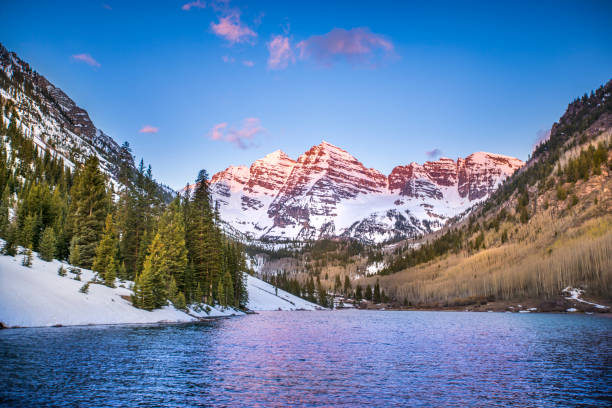 Sunrise near Aspen, Colorado The Rocky Mountains near Aspen, Colorado glow in the light of the morning sunrise, as the mountains and trees reflect off the lake. aspen colorado stock pictures, royalty-free photos & images