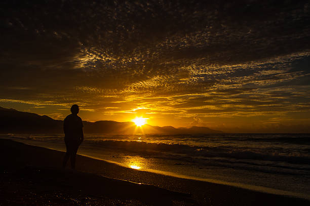 Sunrise on the beach silhouette stock photo