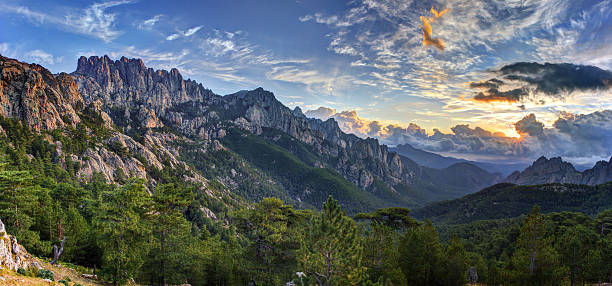 Sunrise over Bavella mountain Sunrise and cloudscape over Bavella massif and mountain, Corsica, France. corsica stock pictures, royalty-free photos & images