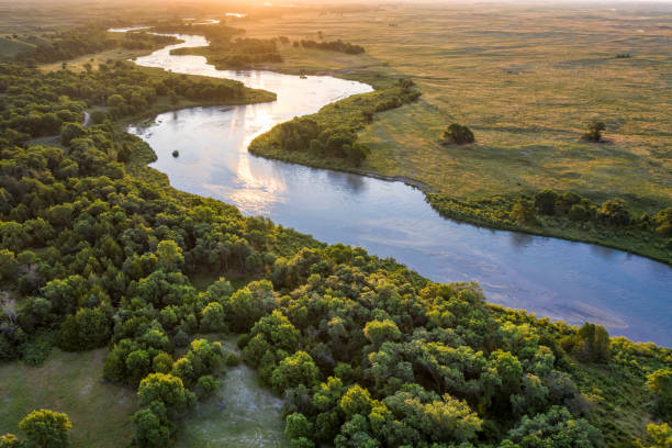 sunrise over Dismal River in  Nebraska Sandhills sunrise over Dismal River meandering through Nebraska Sandhills at Nebraska National Forest, aerial view of summer scenery river stock pictures, royalty-free photos & images