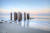 istock Sunrise over old pier on the ocean at Port Royal Beach 1336575779