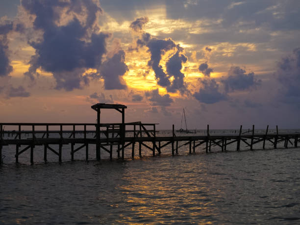 A Sunrise over the Bay with pier destruction in Rockport Texas after Hurricane Harvey stock photo