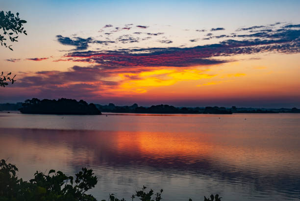 Sunrise reflecting off coastal lagoon stock photo