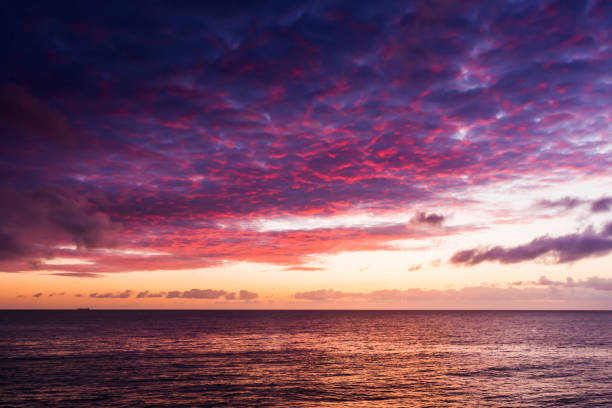 Sunrise with dramatic sky over sea. stock photo