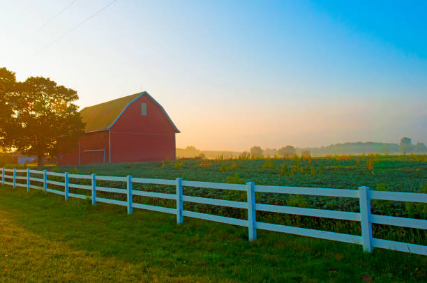 Sunrise with white fence and Red Barn-Wabash County Indiana stock photo
