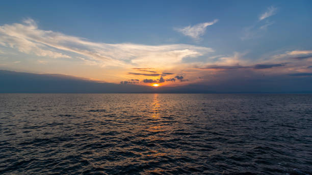 Sunset above calm ocean stock photo