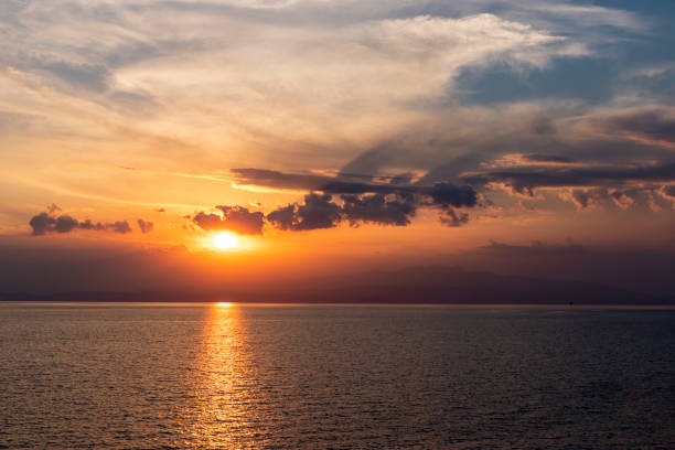 Sunset above calm sea stock photo