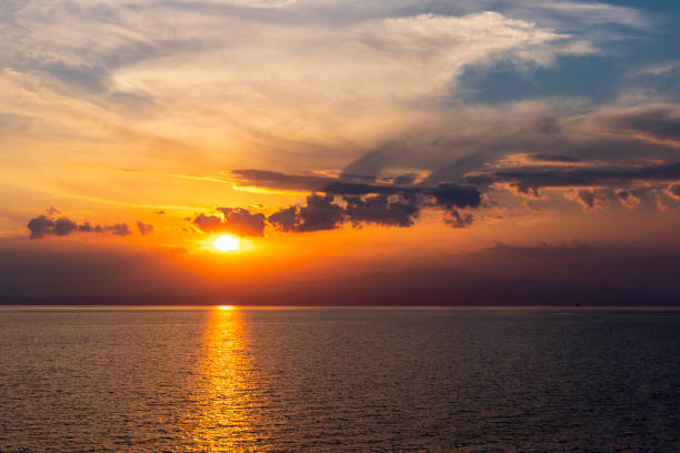 Sunset above calm sea stock photo