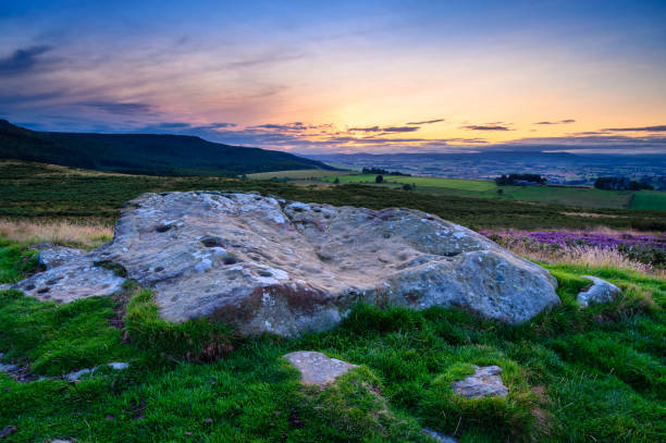 Sunset above Lordenshaws Hillfort Rock Art Lordenshaws Hillfort is located near Rothbury in Northumberland National Park and has several large stones with prehistoric rock art also known as Cup and Ring Marks rothbury northumberland stock pictures, royalty-free photos & images
