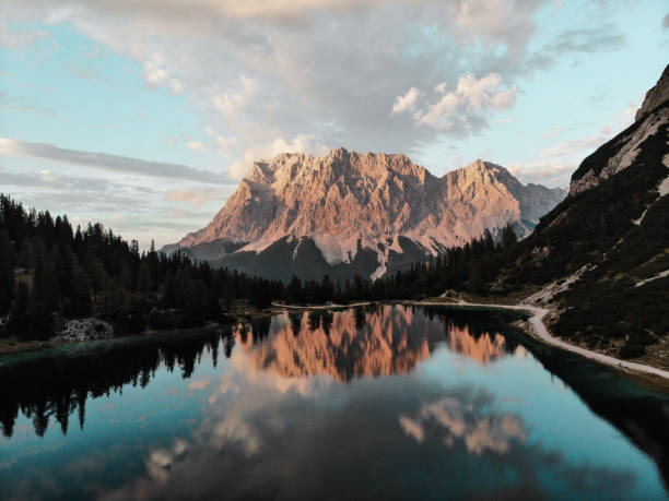 Sunset at european alps (Zugspitze with lake Seebensee) Sunset droneshot at the austrian lake Seebensee with germanys highest mountain Zugspitze in the background austria photos stock pictures, royalty-free photos & images