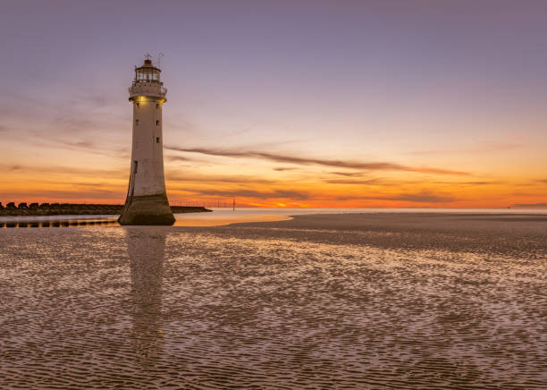 Sunset at New Brighton Lighthouse, Perch Rock, Wirral, Merseyside New Brighton Lighthouse Sunset, Perch Rock, Wirral, Merseyside the wirral stock pictures, royalty-free photos & images