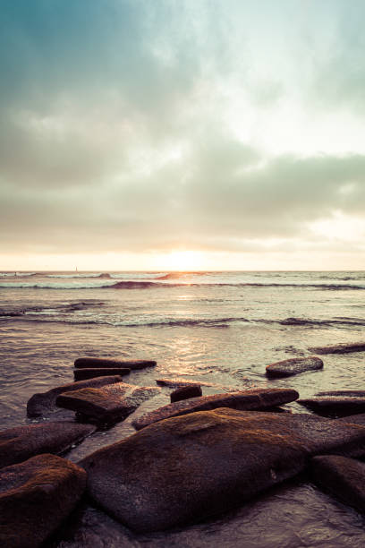 A sunset from a rocky shore stock photo