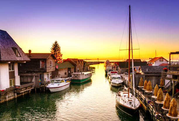 Sunset in Leland, Michigan View of fishtown in Leland, Michigan at sunset peninsula stock pictures, royalty-free photos & images