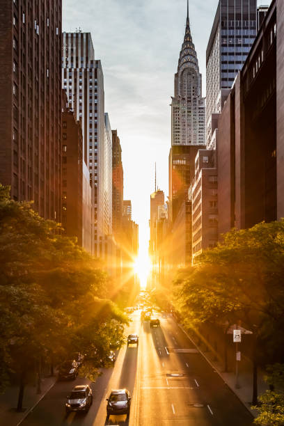 Sunset light shining on the buildings and cars on 42nd Street in Midtown New York City stock photo