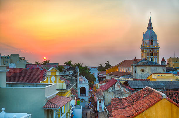 Sunset over Cartagena View over the rooftops of the old city of Cartagena during a vibrant sunset. The spire of Cartagena Cathedral stands tall and proud. latin america stock pictures, royalty-free photos & images