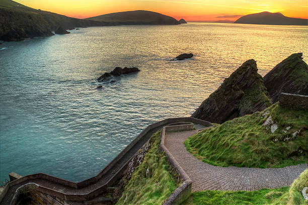 Sunset over Dingle Peninsula, Ireland - HDR Sunset over pathway leading to Dunquin Pier on Dingle Peninsula, Co.Kerry, Ireland - HDR dingle peninsula stock pictures, royalty-free photos & images