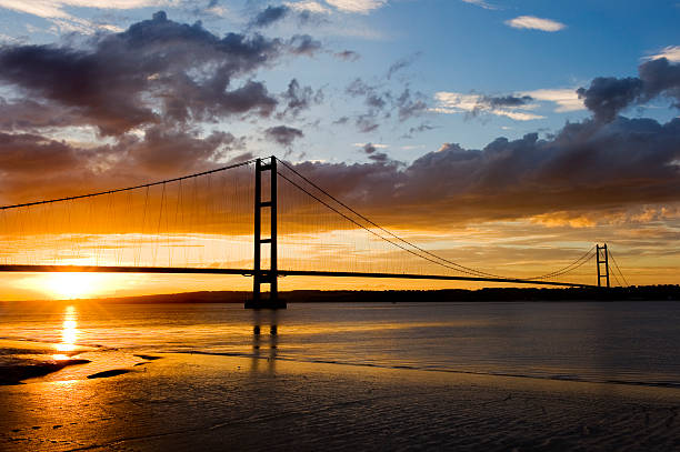 Sunset over Humber Bridge Sun setting over the Humber Bridge, England. hull stock pictures, royalty-free photos & images