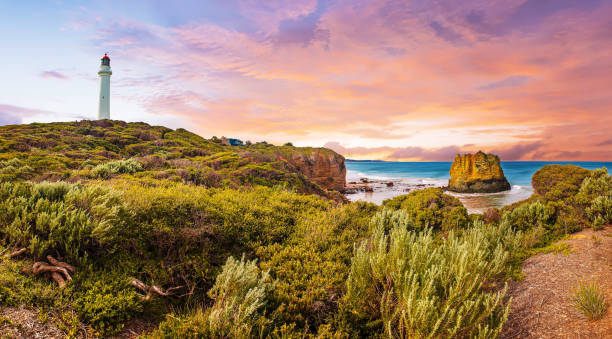 Sunset over Split Point Lighthouse and Eagle rock on Great Ocean Road in Australia stock photo