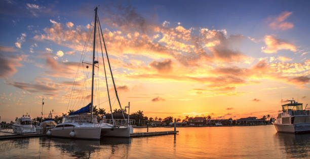 Sunset over the boats in Esplanade Harbor Marina in Marco Island, stock photo