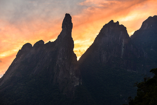Sunset over the famous Dedo de Deus (God's Finger) peak (1.692m) and neighbouring mountains of the Serra dos Órgãos National Park, Teresópolis, Rio de Janeiro state, Brazil