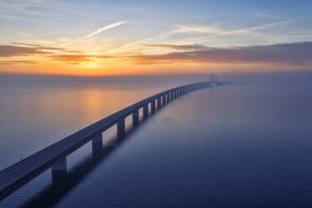 Stunning sunset over the Oresundsbron Oresund bridge between Sweden and Denmark, from Malmö shore. High aerial photograph with drone.