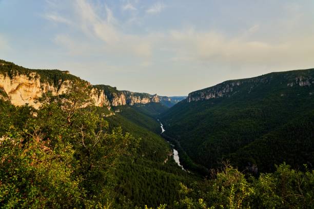 Sunset over the valley of the Gorges Du Tarn and the river Tarn reflects the sky Cevennes National Park during sunset gorges du tarn stock pictures, royalty-free photos & images