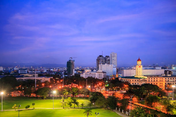 Sunset over view of Manila City Hall from Intramuros, Metro Manila, National Capital Province, Philippines. stock photo