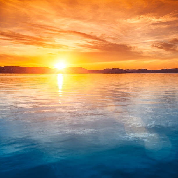 Sunset over water stock photo