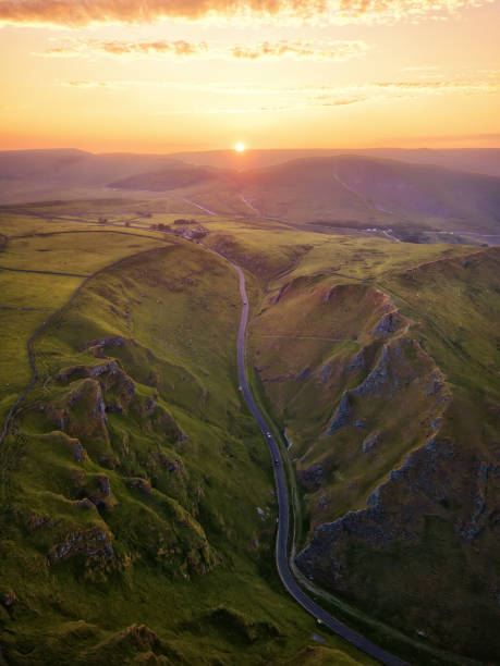 Sunset over Winnats Pass in Peak District United Kingdom Sunset over Winnats Pass in Peak District United Kingdom derbyshire stock pictures, royalty-free photos & images
