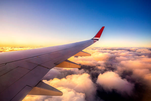sunset sky on airplane, plane window seat over Paris, France, Europe for travel and business trip in weekend holiday and beauty relax view during transportation on sky with cloud stock photo
