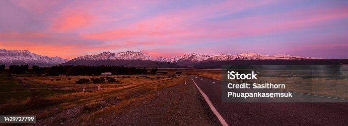 istock Sunset sky on the road  scene with a  Aoraki Mount Cook as green farm field background 1429727799