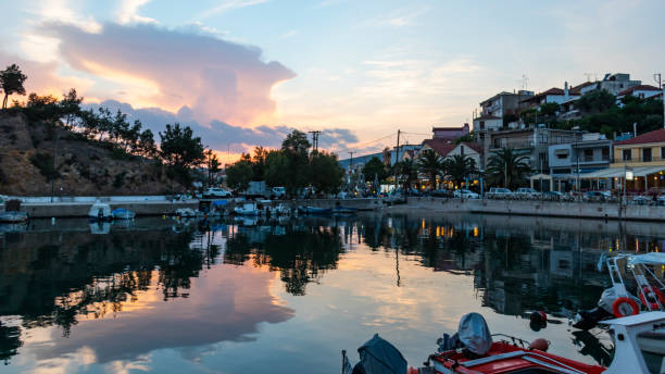 Sunset sky reflecting in water, Limenaria, Thasos, Greece, harbor stock photo