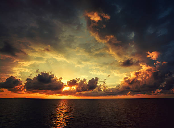 Sunset stock photo Dramatic sunset over the sea. Italy, Liguria. dramatic sky stock pictures, royalty-free photos & images