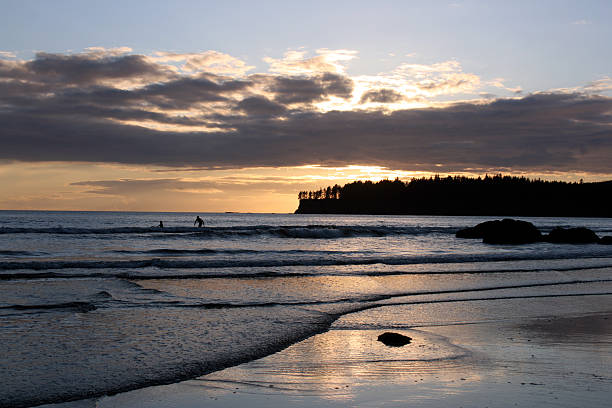 Sunset surfer on Makah Bay Surfers on Makah Bay at sunset.  This beach is 4 miles southwest of Neah Bay on the Makah Reservation at the Northwest tip of Washington State.  Look at more neah bay stock pictures, royalty-free photos & images