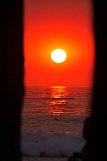 Sunset through Manhattan Beach Pier stock photo