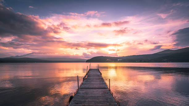 sunset view of Lake Yamanaka Japan, mt.Fuji, view of empty jetty on lake Yamanaka with dramatic sky at dusk natural landmark stock pictures, royalty-free photos & images