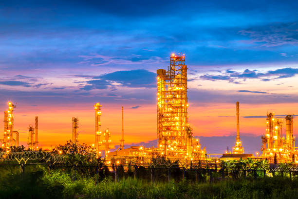 sunset view of refinery petroleum and petrochemical plant industrial with distillation column and engineering equipment and pipe in manufactory for chemistry gas and power energy technology production stock photo