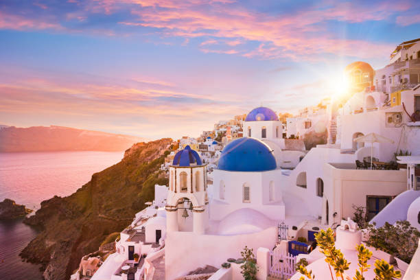 Sunset view of the blue dome churches of Santorini, Greece stock photo