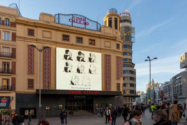 Sunset view of walking people at Callao Square (Plaza del Callao) in City of Madrid, Spain stock photo