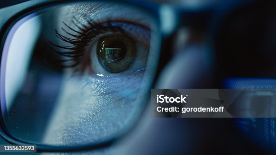 istock Super Close-up on Female Eye, Software Engineer Working on Computer, Programming Reflecting in Glasses. Developer Working on Innovative e-Commerce Application using Machine Learning, AI, Big Data 1355632593
