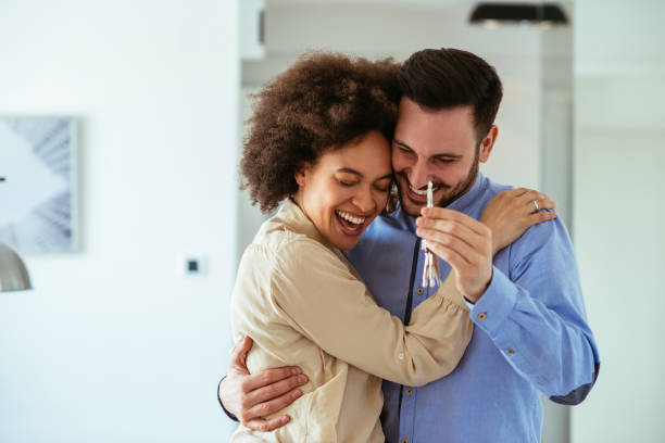 Super excited about our new home! Portrait of young couple feeling happy about buying a new house. home ownership stock pictures, royalty-free photos & images