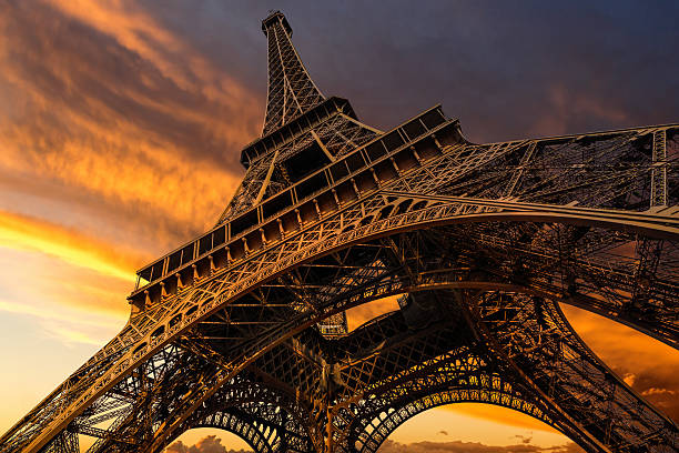 Super wide shot of Eiffel Tower under dramatic sunset Super wide shot of Eiffel Tower under dramatic sunset, Paris, France eiffel tower paris photos stock pictures, royalty-free photos & images