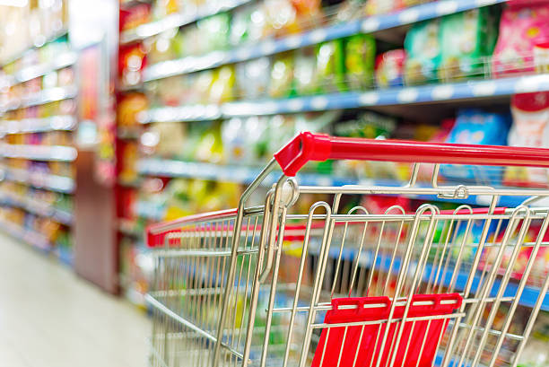 supermarket cart Supermarket interior, empty red shopping cart. push cart stock pictures, royalty-free photos & images