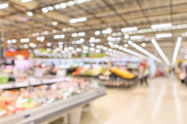 supermarket interior with grocery product blurred defocused background with bokeh light supermarket interior with grocery product blurred defocused background with bokeh light department store photos stock pictures, royalty-free photos & images