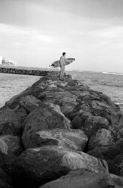 Surfer at the Breakwater stock photo