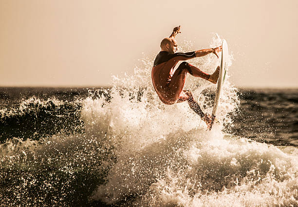 Surfer catching the best wave at sea. stock photo
