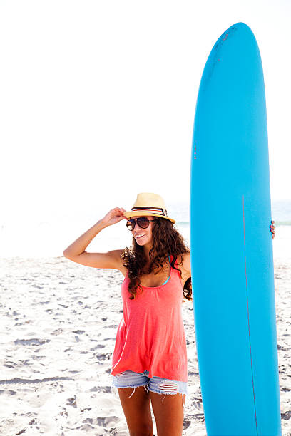 Surfer Girl Young woman holding surfboard. foamcore stock pictures, royalty-free photos & images